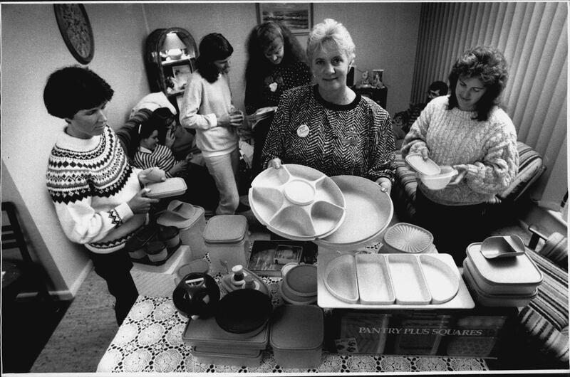 A Tupperware seller, second from right, giving a rundown on products to party goers, 1989. Photograph: Craig Golding/Fairfax Media via Getty