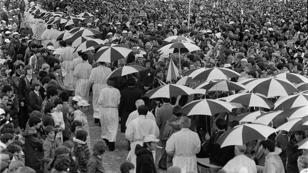 Pope John Paul II’s visit to Ballybrit Racecourse in Galway in 1979. Escorts hold umbrellas over the priests who are administering Holy Communion.