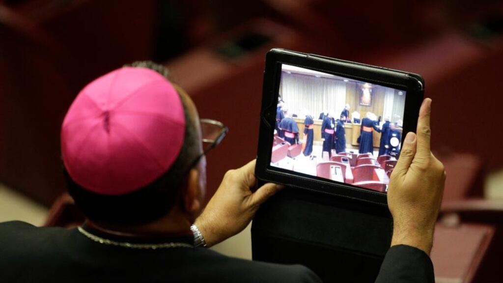 A bishop takes a picture with a tablet during a synod of bishops in Paul VI’s hall at the Vatican today. Photograph: Max Rossi/Reuters