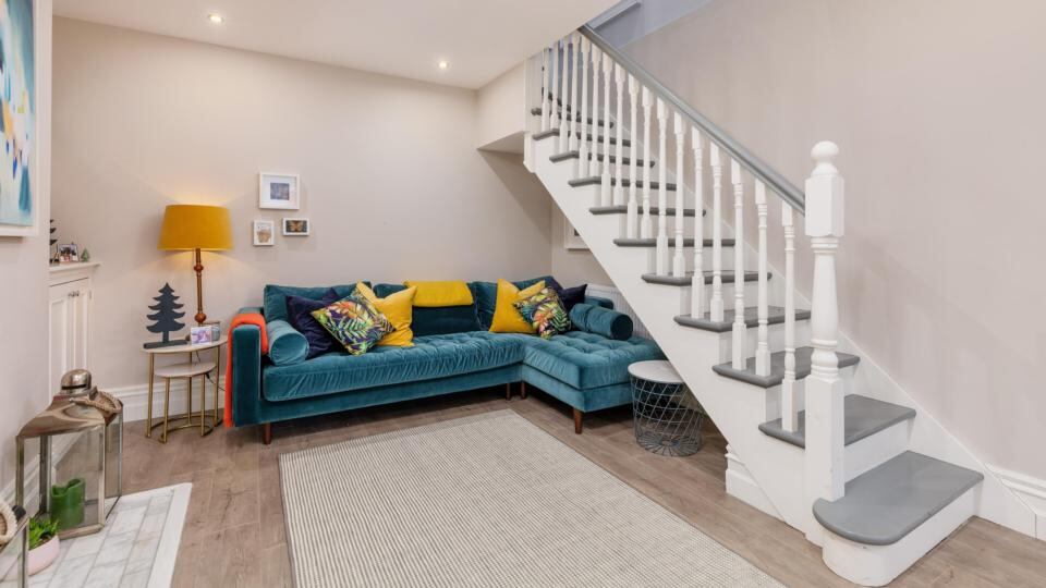 The living room, with stairs going up to the kitchen cum dining room.