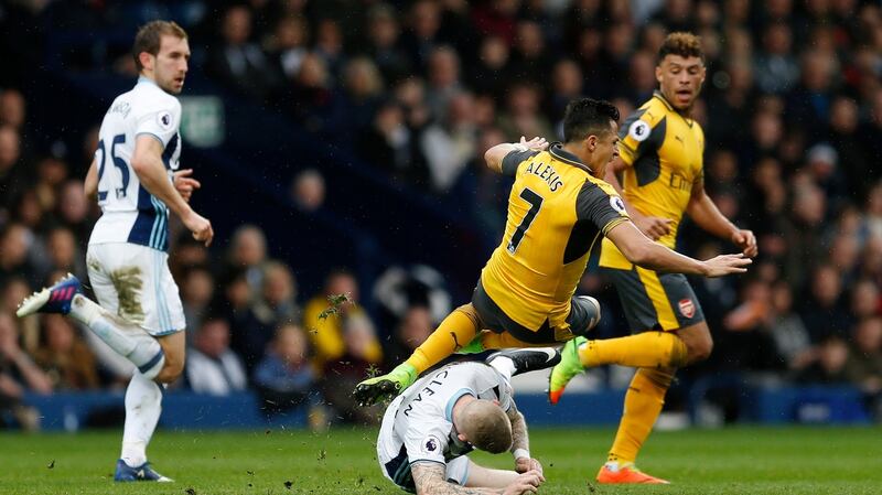 James McClean put in a typically tought tackle which forced Alexis Sanchez off injured. Photo: Andrew Boyers/Reuters