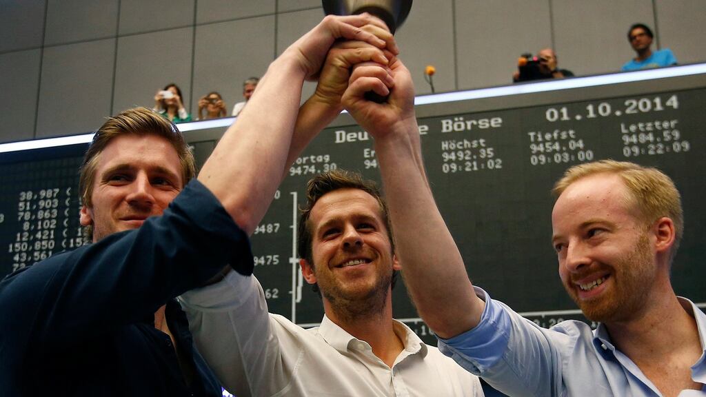 David Schneider, Robert Gentz and Rubin Ritter ring the bell during the initial public offering of Zalando, at the Frankfurt stock exchange October 1, 2014.