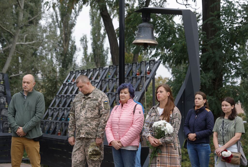 Ukrainians attend a prayer service for fallen defenders of Ukraine, near the Heroes of the Heavenly Hundred memorial commemorating those who died at Maidan Square during the 2014 anti-government protests in Kyiv.
