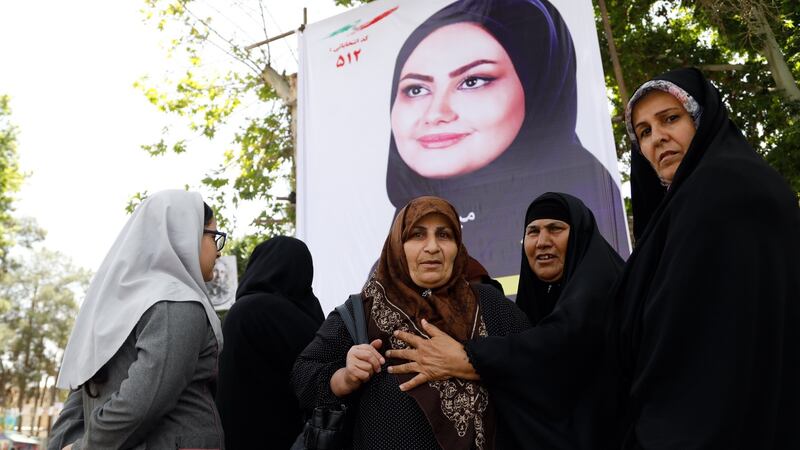 Iranian women at an election banner of Shaghayegh Mirzayi who is standing in municipal elections in the city of Varamin. The municipal elections which will be held at the same time as the presidential election – May 19th, 2017. Photograph: Abedin Taherkenareh/EPA