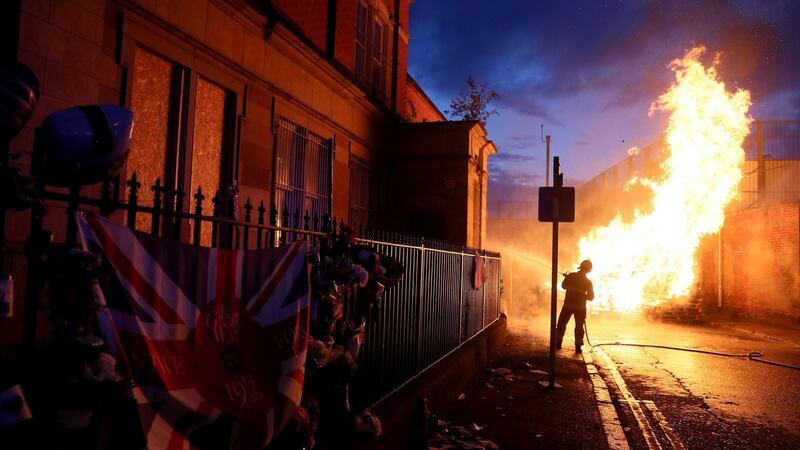 Members of the fire service work to contain the bonfire on Cluan Place, Belfast on Thursday night. Photograph: Brian Lawless/PA