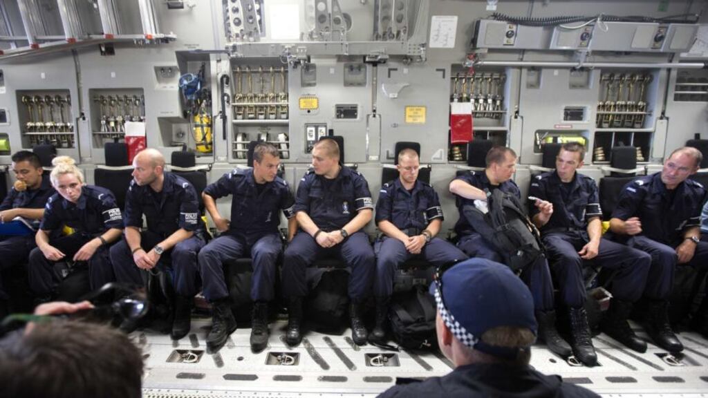 Dutch, Australian and Malaysian members of the repatriation mission of the MH17 plane crash get ready for departure to the Netherlands at the airport in Kharkiv, Ukraine today. Photograph: Jerry Lampen/ EPA