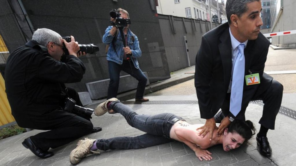 A Femen activist is detained by a security man after staging a protest during a visit by Tunisian prime minister Ali Larayedh near the European Commission in Brussels last month. Photograph: Reuters/Laurent Dubrule