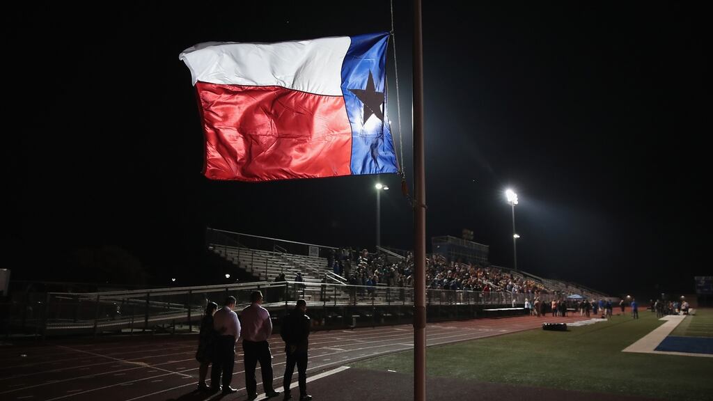 A Texas flag flies at half mast during a prayer services at the La Vernia High School Football stadium to grieve the 26 victims killed at the First Baptist Church of Sutherland Springs on November 7th, 2017. Photo: Scott Olson/Getty Images
