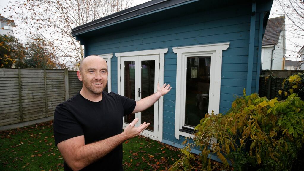 Welcome to the office: David Rochford outside the log cabin he uses as a home office in his garden in Ongar, Dublin 15. Photograph: Nick Bradshaw