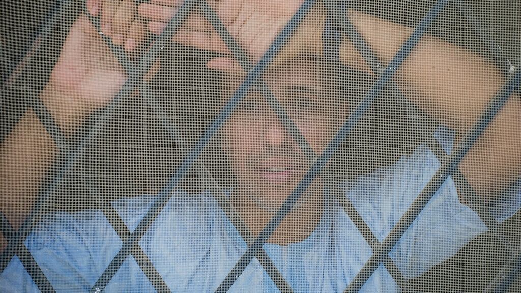 Mohamedou Ould Slahi, who underwent brutal interrogations while he was held at Guantánamo Bay 15 years ago, looks out a window of his home in Nouakchott, Mauritania. Photograph: Btihal Remli/The New York Times