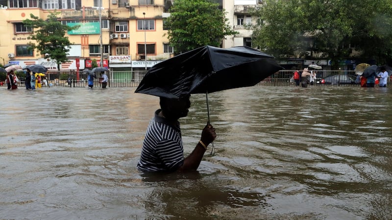A man wades through a waterlogged street following heavy rains in Mumbai on Tuesday. Photograph: Rajanish Kakade/AP