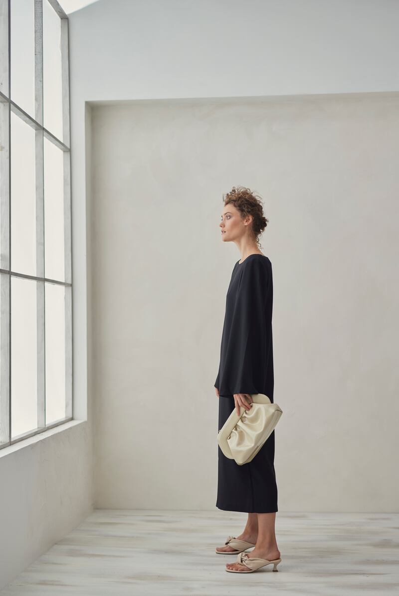 Wide sleeve black dress €315 by Stylein, vegan leather bag €270 by Themoire. Photograph: Dylan Madden