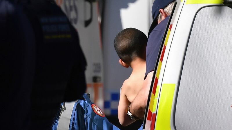 Three-year-old Anthony Elfalak is carried by a paramedic into an ambulance after he is found on the family property on Monday. Photograph: AP