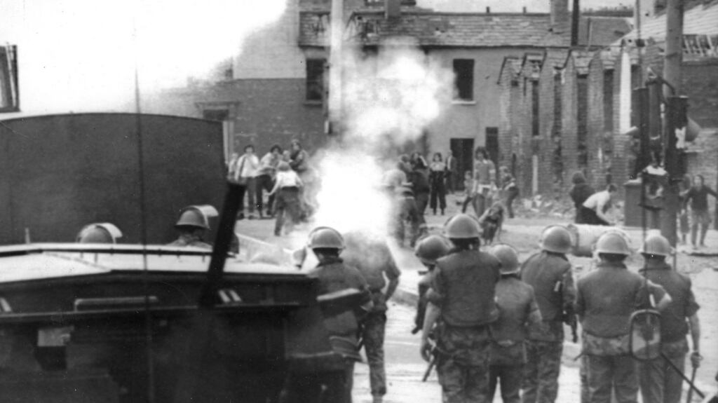 British soldiers fire rubber bullets and use a water cannon at Divis flats in Belfast in July 1973.