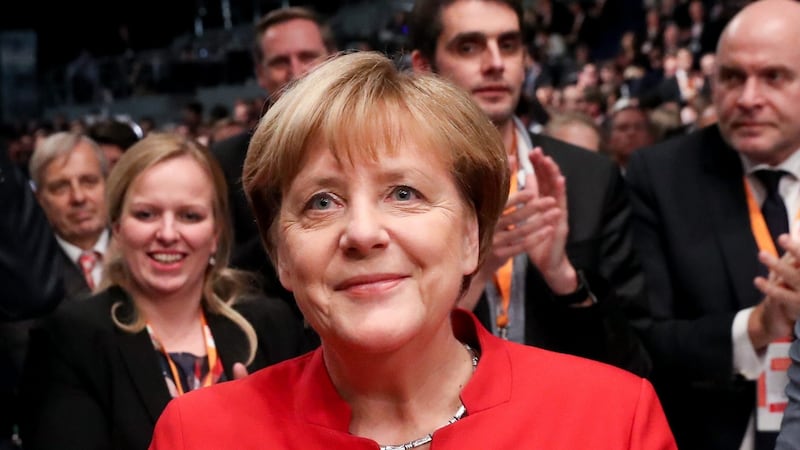 Chancellor Merkel reacts after securing her reelection to the position of head of the party at the convention. Photograph: Michael Kappeler/EPA