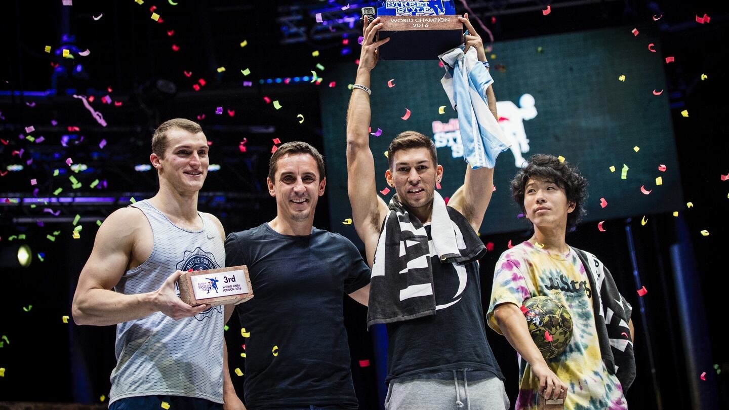 Anatoly Yanchev of Russia 3rd place, guest judge Gary Neville, Carlos Alberto Iacono of Argentina 1st place and Kosuke Takahashi of Japan 2nd place celebrates during the finals of the freestyle football world championship Red Bull Street Style in London. Photo: Red Bull Content Pool