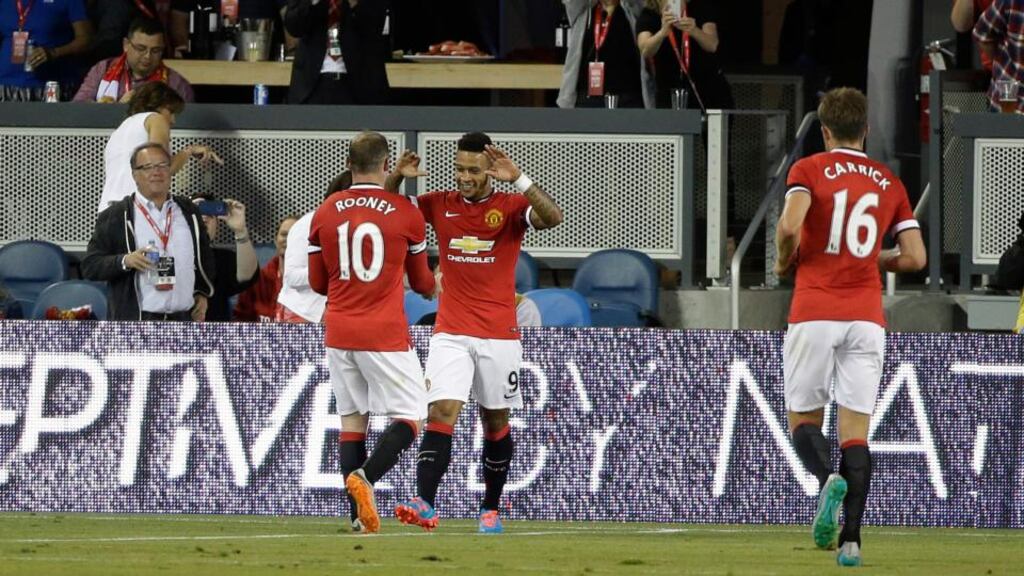 Manchester United’s Memphis Depay is greeted by teammates Wayne Rooney, and Michael Carrick after scoring a goal in the first half of an International Champions Cup soccer match against the San Jose Earthquakes. Photograph: Eric Risberg/AP