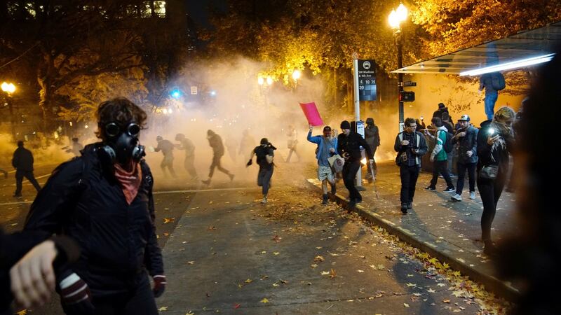 People try to move away from a gas cloud during a protest against the election of Republican Donald Trump as President of the United States in Portland, Oregon on Saturday. Photograph: Reuters