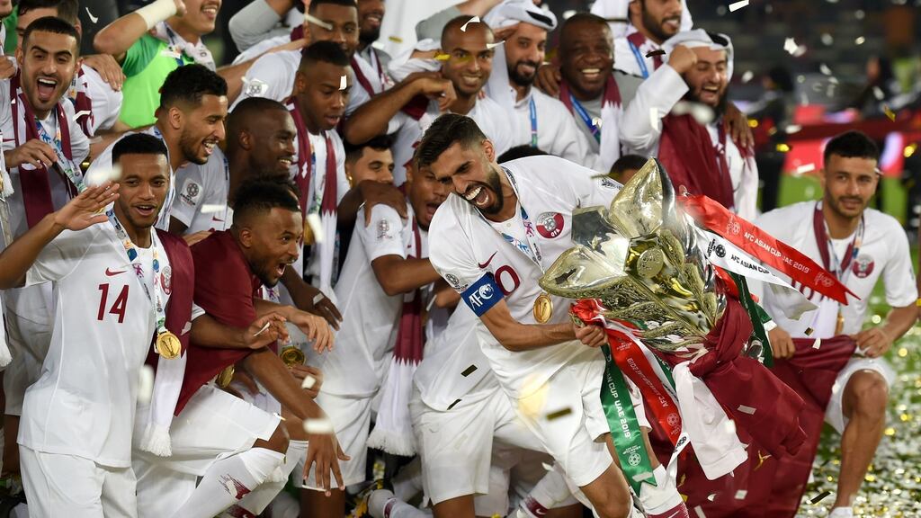 Qatar forward Hasan Al Haydos with the trophy after last year’s Asian Cup final against Japan. Photograph: Getty Images