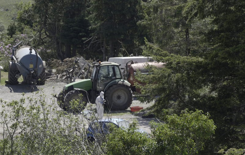 A member of Garda Technical Unit at the scene at missing Kerry farmer Michael Gaine's farm in Carrig East, Kenmare. Photograph: Noel Sweeney/PA Wire