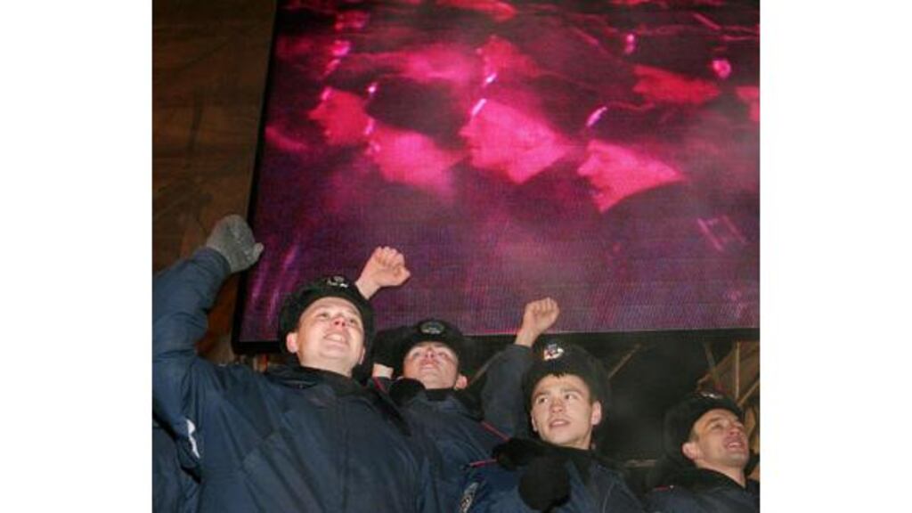 Ukraine cadets raise their arms in support of opposition leader liberal Viktor Yushchenko during a mass rally in Kiev's Independence Square yesterday