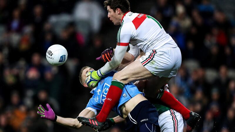 Dublin’s Eoghan O’Gara collides with David Clarke and Lee Keegan of Mayo. Photo: Tommy Dickson/Inpho