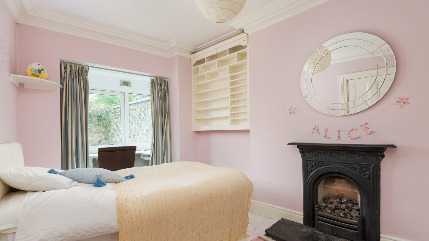 The larger bedroom with fireplace.