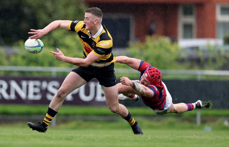 Young Munster’s Fionn Gibbons with Michael Courtney of Clontarf during the sides' clash at Castle Avenue on Saturday. Photograph: Dan Sheridan/Inpho