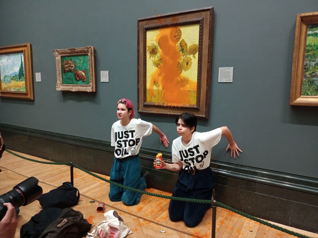 Just Stop Oil protesters in front of the Vincent Van Gogh's 1888 work Sunflowers at the National Gallery in London on Friday. Photograph: Just Stop Oil group/PA