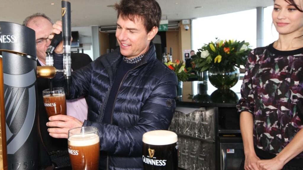 Tom Cruise at one of Dublin’s biggest tourist attractions, the Guinness Storehouse, alongside fellow actor Olga Kurylenko and Guinness Master Brewer Fergal Murray. Photograph: Leon Farrell/ Photocall Ireland