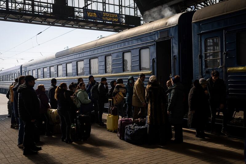 Ukrainians escaping from the besieged city of Mariupol along with other passengers from Zaporizhzhia gather on a train station platform after arriving at Lviv, western Ukraine, on Sunday. Photograph: AP Photo/Bernat Armangue