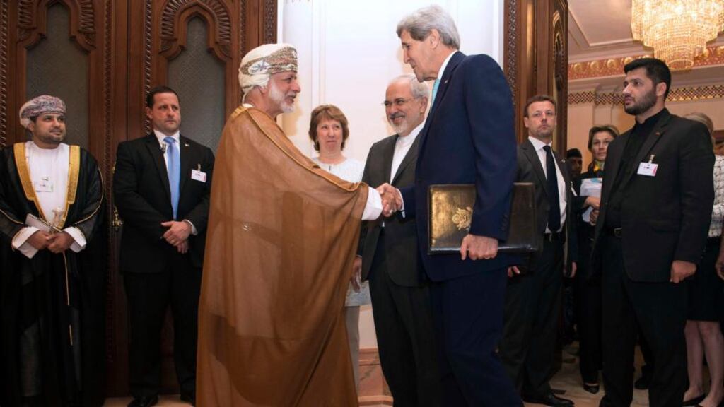 US secretary of state John Kerry shakes hands with Oman’s foreign minister Yussef bin Alawi as EU envoy Catherine Ashton and Iran’s foreign minister Javad Zarif watch before talks on Tehran’s nuclear programme began in Muscat on Sunday. Photograph: Nicholas Kamm/Reuters