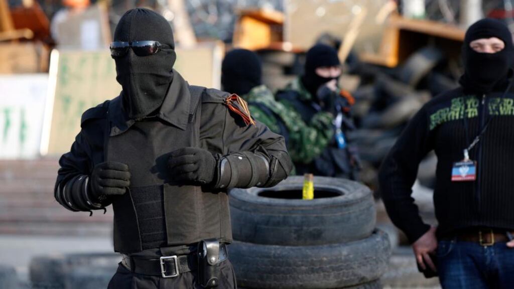 Masked pro-Russia protesters stand guard outside a regional government building in Donetsk, in eastern Ukraine today. Photograph: Reuters