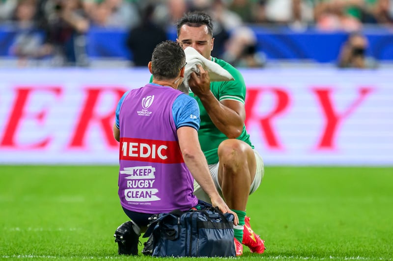 James Lowe has his eye injury looked at by Ireland physio Stephen Mutch. Photograph: Craig Watson/Inpho