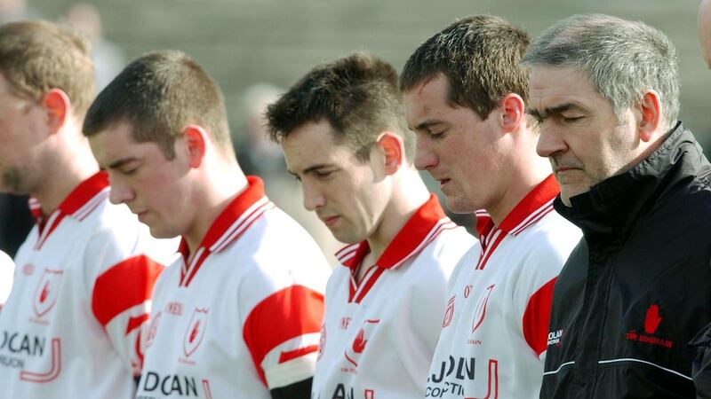 Tyrone players and manager Mickey Harte observe a minute’s silence in memory of Cormac McAnallen before a National League match in 2004. Photograph: Inpho