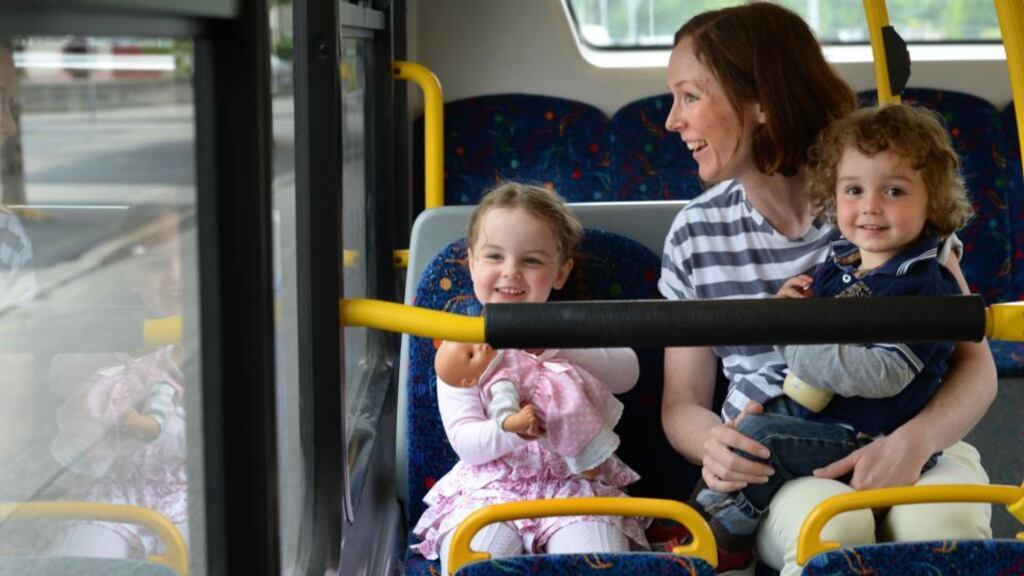 Claire Micks with her children, Lucy (4) and Andy (2), on the 83 bus going into Dublin city. Photograph: Dara Mac Dónaill