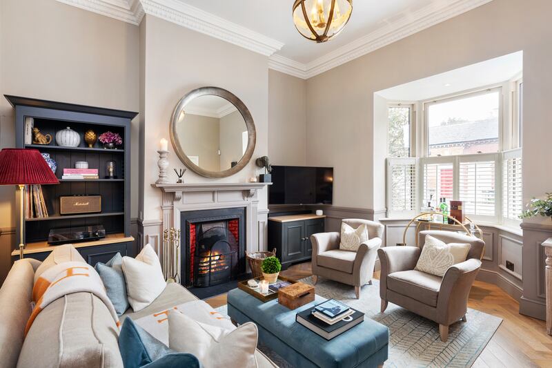 The room to the front of the property, which benefits from a bay window, has been given a swish overhaul, with new herringbone parquet flooring that extends into the hall.