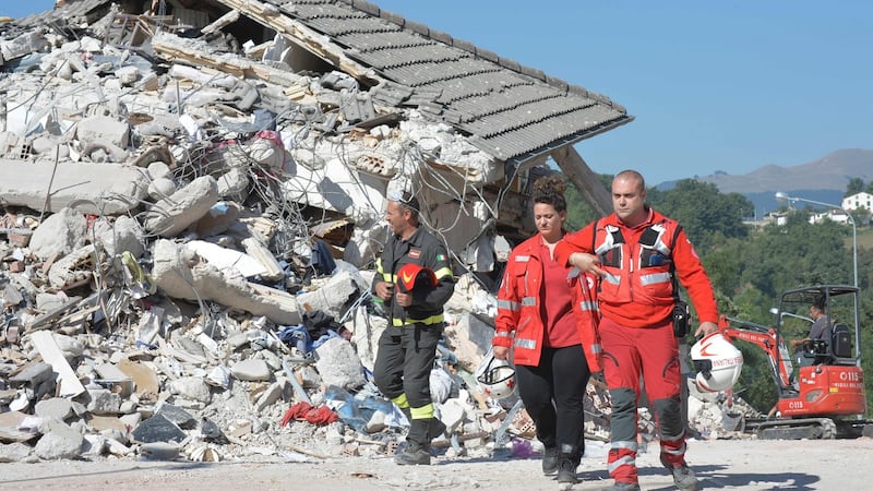 A firefghter and rescuers walk near rubble and debris of a destroyed building in the damaged central Italian village of Amatrice on August 26th, two day after a 6.2-magnitude earthquake struck the region killing some 250 people. Photograph: Andreas Solaroandreas Solaro/AFP/Getty Images