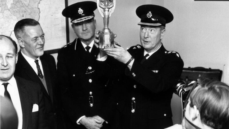 Chief Superintendent William Gilbert lifts the Jules Rimet trophy on March 28th 1966. Photograph: Central Press/Getty