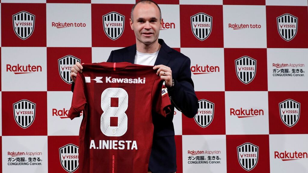 Former Barcelona midfielder Andres Iniesta poses with his new jersey. Photograph: Toru Hanai/Reuters