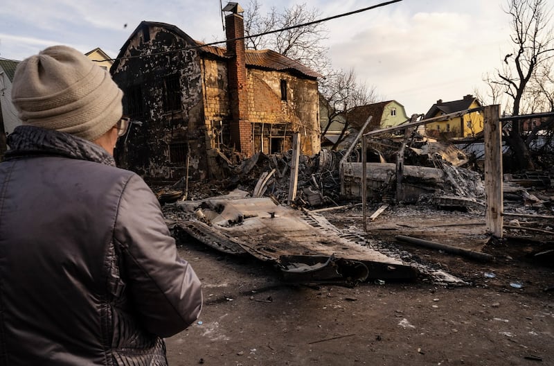 A woman looks across debris from a downed aircraft in Kyiv on Friday. Photograph: Lynsey Addario/The New York