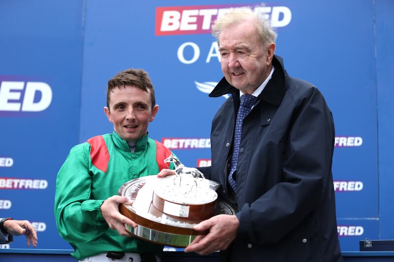 Jockey Chris Hayes and trainer Dermot Weld with the trophy after winning the Betfred Oaks onboard Ezeliya at the Derby Festival at Epsom Downs. Photograph: Stephen Paston/Jockey Club/PA