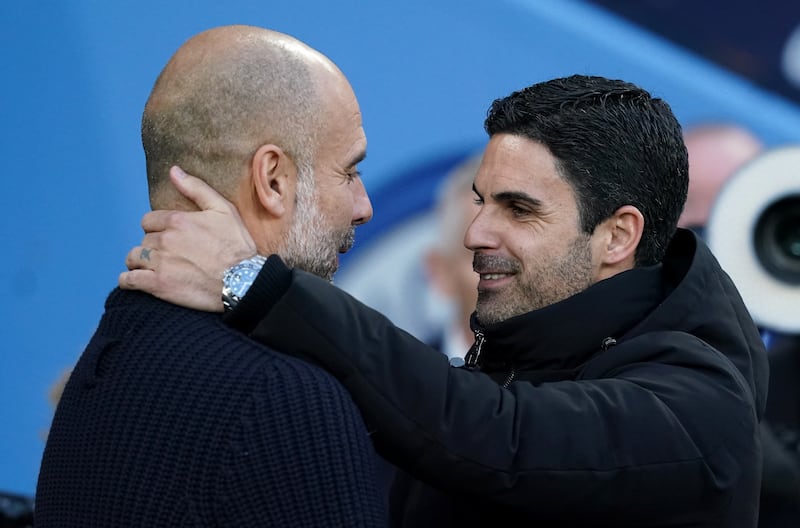 Manchester City manager Pep Guardiola (left) and Arsenal manager Mikel Arteta embrace before the Premier League match at the Etihad Stadium, Manchester. Photograph: PA