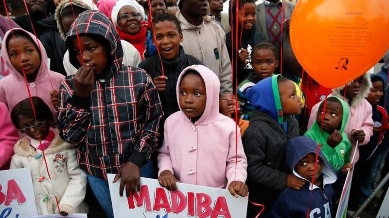 Wellwishers hold balloons outside the hospital today. Photograph: Mike Hutchings/Reuters