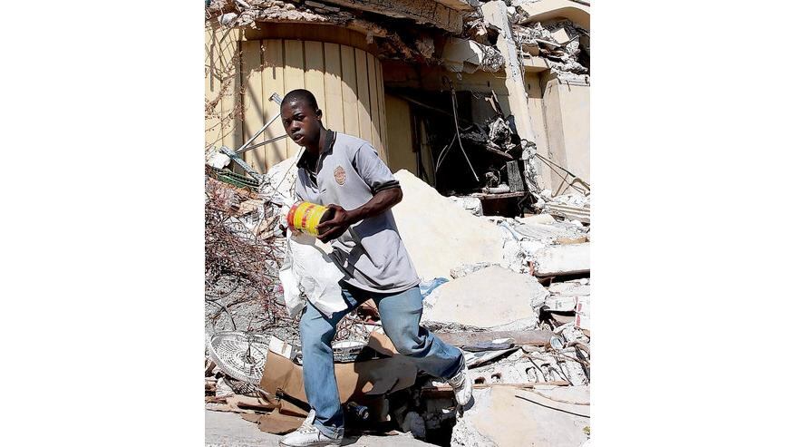 a man looting from the Caribbean shopping centre