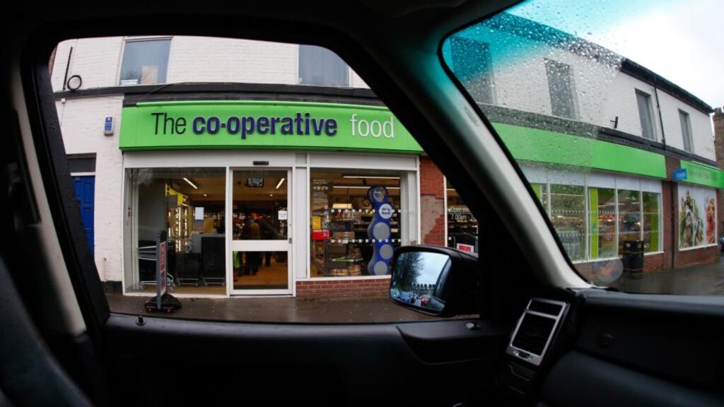A Co-Operative Food store, operated by the Co-Operative Group , is seen through the passenger window of an automobile in Disley, UK. Photographer: Paul Thomas/Bloomberg