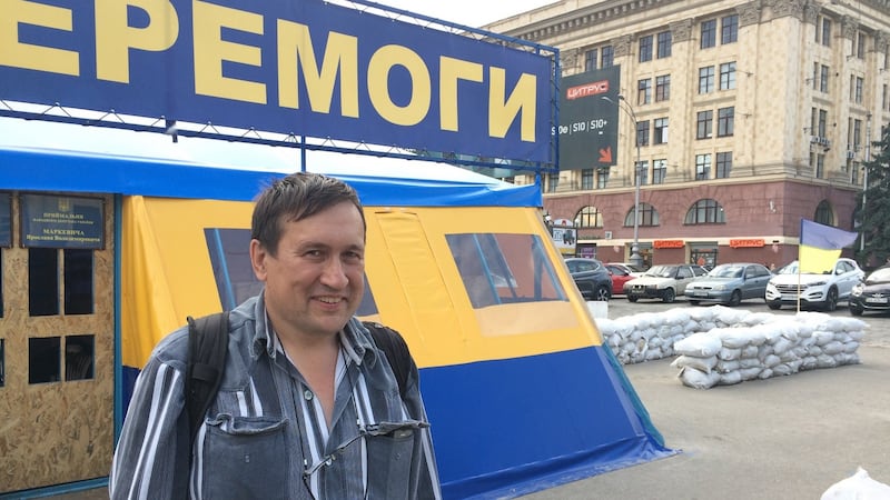 Activist Boris Redin beside a tent in the eastern Ukrainian city of Kharkiv, where volunteers collect money for the country’s war effort. City mayor Hennadiy Kernes wants to remove the tent. Photograph: Daniel McLaughlin