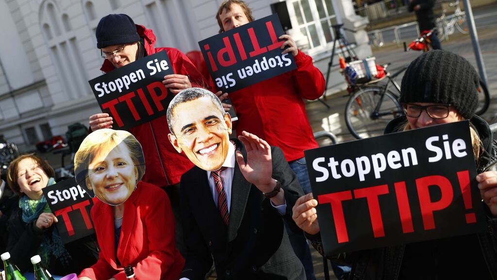 Protesters wear masks of US President Barack Obama and German Chancellor Angela Merkel as they demonstrate against Transatlantic Trade and Investment Partnership (TTIP) free trade agreement before the opening ceremony of the Hannover Messe in Hanover, Germany on April 24th. Photograph: REUTERS/Kai Pfaffenbach