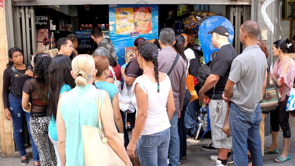 People queue to buy food at a mini market in downtown Caracas, Venezuela. Smurfit’s local unit represents less than 1 per cent of core earnings