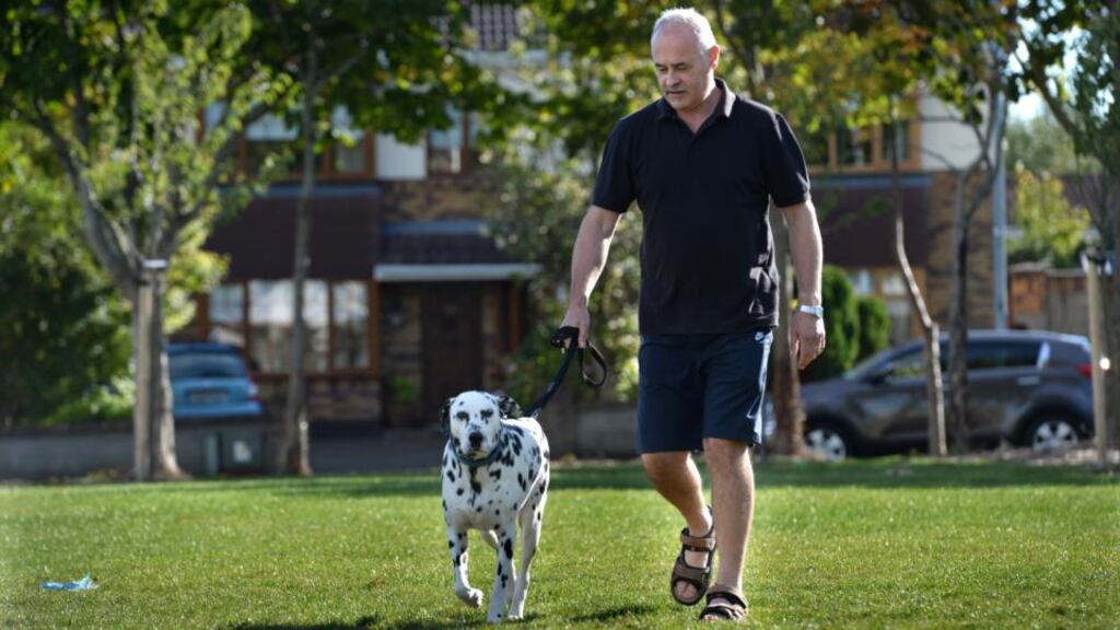 ’Your concentration drops and your motivation goes’: Terry O’Connor, who is unemployed, with his dog, Lewis. Photograph: Dara Mac Dónaill